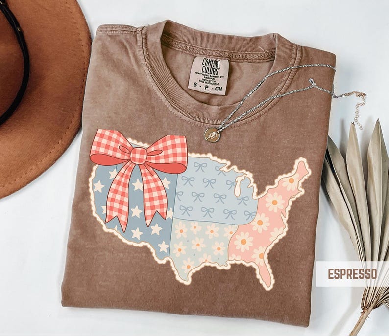 a brown t - shirt with a red bow and a map of the united states