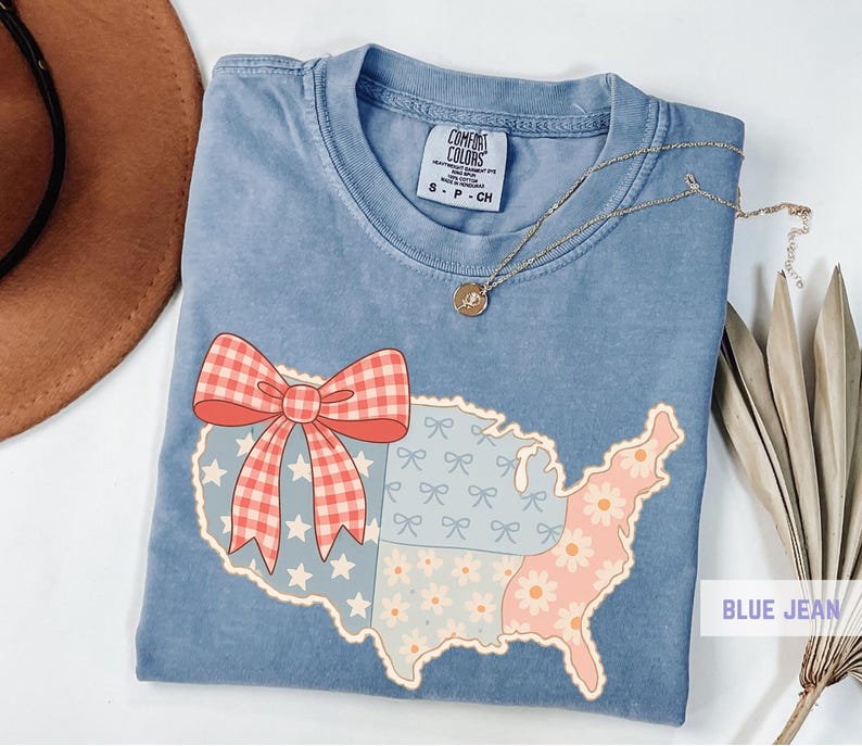 a blue shirt with a red bow and a map of the united states