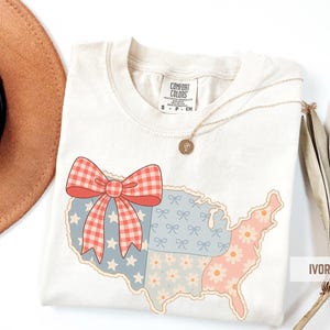 a hat, sunglasses, and a t - shirt with the united states of america