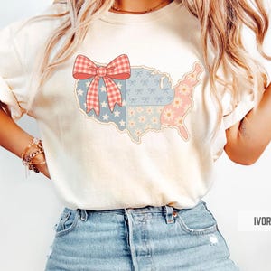 a woman wearing a t - shirt with a bow on it
