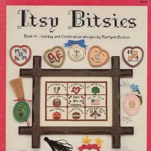 Puede incluir: Un libro titulado "Itsy Bitsies" con una portada que presenta una variedad de diseños de punto de cruz para fiestas y celebraciones. Los diseños incluyen corazones, calabazas y un gorro de graduación.