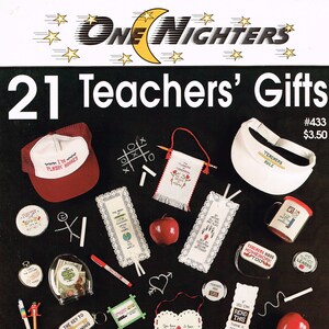 May include: A collection of 21 cross-stitch patterns for teacher gifts. The patterns include a variety of designs, such as apples, books, pencils, and hearts. The patterns are all in black and white and are printed on a white background. The text on the page reads "21 Teachers' Gifts" and "Jeanette Crews Designs, Inc."