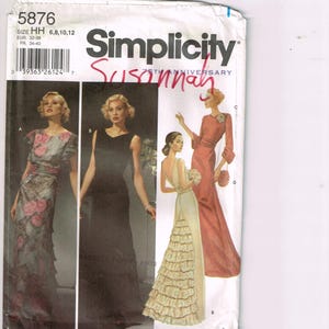 May include: A vintage Simplicity sewing pattern, featuring illustrations of elegant evening gowns. The pattern cover includes the number 5876, size details, and the Simplicity logo. The word "Susannah" is handwritten on the cover.