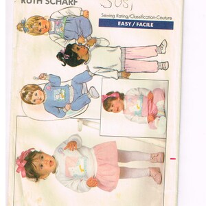 May include: Butterick sewing pattern 5791 featuring illustrations of children's clothing. The pattern includes images of a child in a blue outfit, a child in a white sweater and pink pants, and a child in a pink skirt and white sweater.