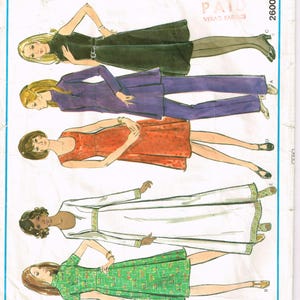 May include: A vintage Vogue's Basic Design sewing pattern featuring illustrations of women's clothing. The cover displays a black dress, a purple pantsuit, a red dress, a white dress with gold trim, and a green floral dress. The text "Vogue's Basic Design" is at the top.