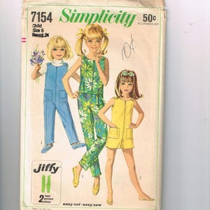 May include: A vintage Simplicity sewing pattern for children's clothes. The pattern shows illustrations of three girls in different outfits: blue dungarees, a floral jumpsuit, and a yellow romper. The pattern includes the text "Jiffy" and "easy cut - easy sew".