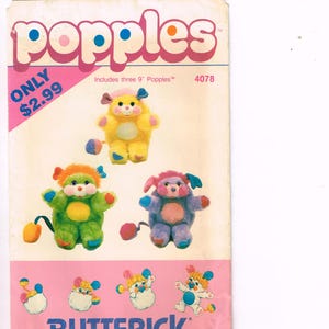May include: A vintage Butterick pattern featuring Popples plush toys. The pattern includes instructions for making three 9-inch Popples. The cover is pink and white with the word "Popples" in large, bubble letters. The pattern number is 4078.