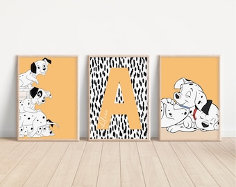 May include: Three framed art prints featuring Dalmatian puppies and the letter "A". The prints have a light orange background. The Dalmatian prints are black and white. The letter "A" print has a black and white dalmatian spot pattern.