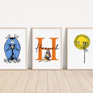 May include: Three framed prints featuring characters from the Nightmare Before Christmas. The first print shows Jack Skellington in a blue oval with a black heart. The second print shows Sally sitting in a large orange letter H with the name "Hannah" above her. The third print shows Jack Skellington in a yellow circle with a black heart.