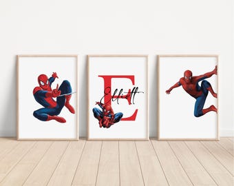 May include: Three framed prints featuring a red and blue Spiderman character. The middle print has a large red letter "E" with the name "Elliott" written in black cursive.