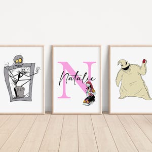 May include: Three framed prints featuring characters from the Nightmare Before Christmas. The first print shows Jack Skellington standing on a tombstone. The second print shows the letter N in pink with the name Natalie written in black. The third print shows the character Oogie Boogie holding a red heart.