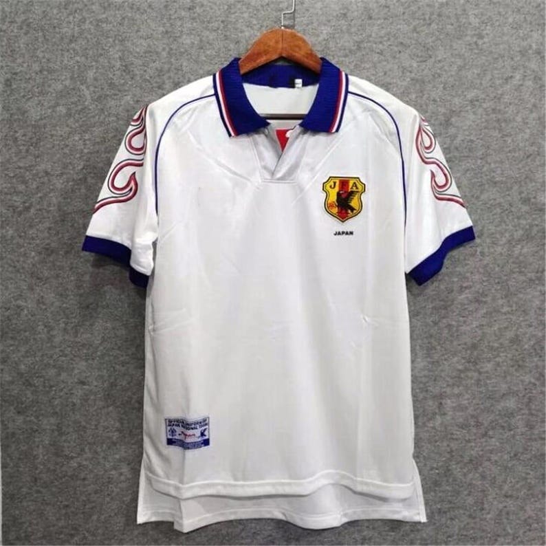 Japan 1998 jersey
Retro Japan shirt
Vintage Japan kit
Samurai Blue 1998
Japan World Cup 98
Classic Japan shirt
Japan away jersey 98
Japan football shirt
Flame design jersey
JFA 1998 kit
Retro soccer top
World Cup Japan shirt
Japan national team kit