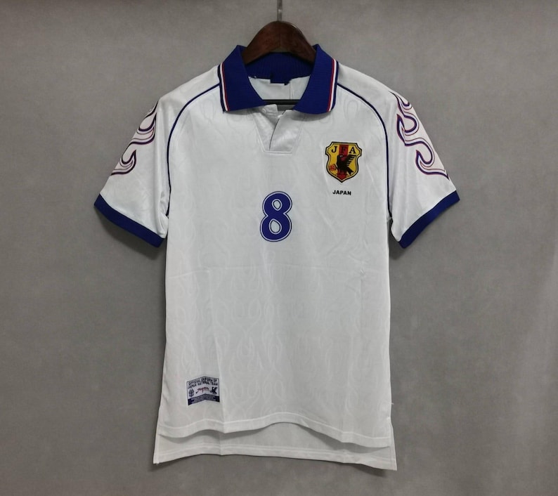 Japan 1998 jersey
Retro Japan shirt
Vintage Japan kit
Samurai Blue 1998
Japan World Cup 98
Classic Japan shirt
Japan away jersey 98
Japan football shirt
Flame design jersey
JFA 1998 kit
Retro soccer top
World Cup Japan shirt
Japan national team kit