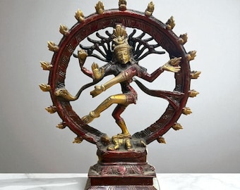 May include: A bronze statue of the Hindu deity Shiva Nataraja, the Lord of Dance. The statue features a figure with multiple arms and a halo of flames, in a dynamic dancing pose. The statue is approximately 12 inches tall.