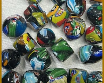 May include: A collection of colorful glass beads with intricate patterns. The beads are a mix of shapes, including round and faceted, and feature swirls of blue, green, yellow, and red. These decorative beads are ideal for jewelry making and craft projects.
