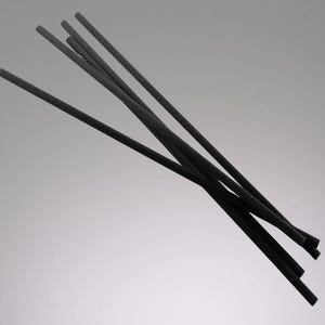 May include: A set of black diffuser sticks, used to disperse fragrance in a room.