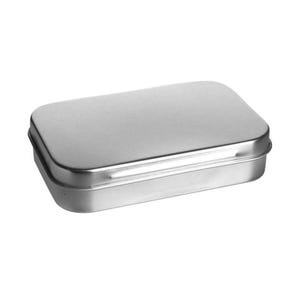 May include: A small, rectangular, silver-colored metal tin with a rounded lid. The tin is empty and has a simple, minimalist design. The lid fits snugly over the base, creating a secure closure. This container is suitable for storing small items.
