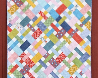 May include: A colorful quilt pattern called "Picnic" featuring a mix of bright colors and patterns. The quilt is made with fat quarters and is available in six sizes. The pattern is available as a PDF download.