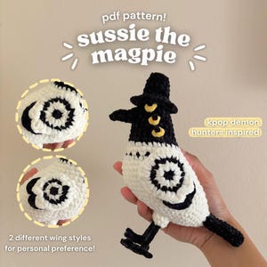 May include: A crocheted magpie doll in black and white, with a black hat and yellow accents. The doll has two wing style options. Text on the image reads "sussie the magpie" and "kpop demon hunters inspired."