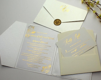 May include: A white wedding invitation with gold foil accents. The invitation features a floral design and the names "Johanna Emily Smith & Alfred Brooks". The RSVP card is included in the invitation.