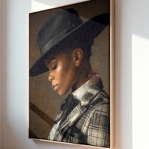 May include: A framed wall art print featuring a side profile portrait of a person wearing a wide-brimmed black hat and a black and white plaid blazer over a white collared shirt with a black necktie, set against a textured dark brown background.