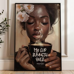 May include: Framed art print featuring a portrait of a woman with closed eyes, holding a black mug with steam rising. The mug has the text "My Cup Runneth Over" and "Psalm 23:5". The woman has flowers in her hair.