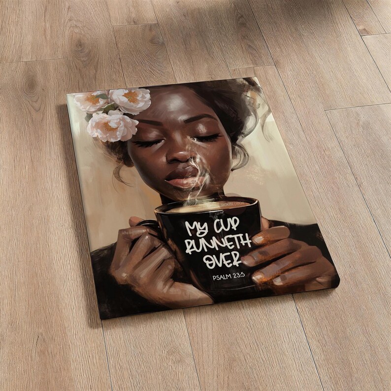 May include: A canvas print featuring a portrait of a person with closed eyes, holding a black mug with the text "My cup runneth over" and "Psalm 23:5". The person has flowers in their hair and steam rising from the mug.