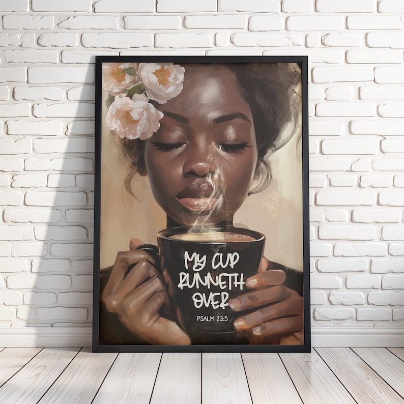 May include: A framed art print depicts a woman with closed eyes, holding a black mug with steam rising. The mug reads "My Cup Runneth Over" and "Psalm 23:5". The woman has flowers in her hair.