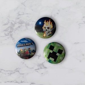 May include: Three round Minecraft themed buttons. The first button features a green creeper face. The second button features a blue sky with clouds and the text "MINECRAFT" and a group of Minecraft characters. The third button features a skull with flames on a dark blue background.