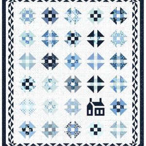May include: A handmade quilt featuring a repeating pattern of blue and white geometric shapes. The quilt has a white background with small gray dots, a dark blue border, and a house silhouette. The quilt is approximately 80 x 90 inches.