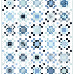 May include: A patchwork quilt in shades of blue and white. The quilt features a repeating pattern of squares and rectangles, with floral and geometric designs. The overall design is symmetrical and the quilt has a white border.