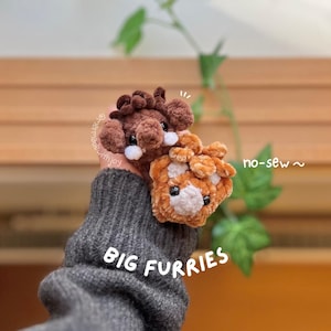 May include: Two plush, no-sew, Big Furries. One is brown, the other is orange and white. The plush toys have black eyes and white accents. The text "BIG FURRIES" is visible in white letters.