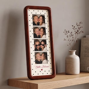 May include: A tall, rectangular dark wood photo frame featuring a white mount with black polka dots. The frame holds four vertical photo slots displaying two people in various poses. The bottom of the mount includes the text Bestie Forever and a red heart.