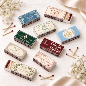 May include: A collection of rectangular matchboxes featuring various personalised designs with names and dates. The boxes display text such as Olivia & Henry, Emma & D, Olivia & Mason, Isabella & Nathan, Sophia & Lucas, Katherine & Thomas, Olivia & Daniel, Emily & James, and Sophia & Daniel, alongside decorative floral, ring, and cake illustrations.