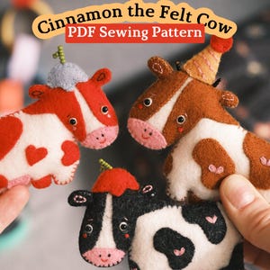 May include: Three felt cow ornaments featuring the text Cinnamon the Felt Cow PDF Sewing Pattern. The cows are red and white with heart spots, brown and white with a party hat, and black and white with a red hat, all with pink muzzles and stitched details.
