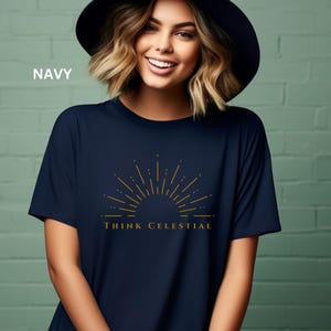 May include: A navy blue t-shirt with a gold sunburst graphic and the text "Think Celestial".