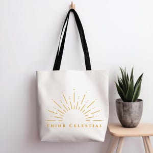 May include: White tote bag with black handles. The bag features a gold sunburst design and the text "THINK CELESTIAL".