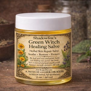 May include: A jar of Shadowfox's Green Witch Healing Salve. The label features text and illustrations of flowers and herbs. The jar is 2 oz / 60 ml. The salve is for herbal skin repair, to soothe, restore, and protect.