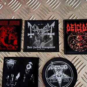 Puede incluir: Colección de parches negros con logotipos y obras de arte de bandas. Incluye parches de Dimmu Borgir, Mayhem, Deicide, Darkthrone y Venom. Cada parche tiene diseños y texto únicos, con un tema de música metal.