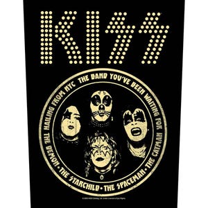 May include: Black graphic featuring the band KISS. The band's name is in a dotted font at the top. Below, a circular design shows the band members' faces with text that reads "The Band You've Been Waiting For".