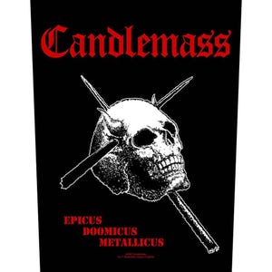 May include: Black and white patch with a skull and crossbones design. The text "Candlemass" is in red at the top of the patch. The text "Epicus Doomicus Metallicus" is in red at the bottom of the patch.