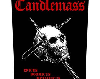 May include: Black and white patch with a skull and crossbones design. The text "Candlemass" is in red at the top of the patch. The text "Epicus Doomicus Metallicus" is in red at the bottom of the patch.