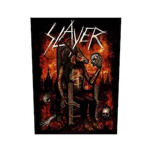 May include: A black graphic with the white word "SLAYER" in a gothic font. The image shows a demonic figure on a throne, holding a skull, set against a fiery backdrop with skulls. The artwork has a dark, gothic theme.