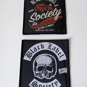May include: Two black patches with white and orange text. The top patch reads "Black Label Society" with a car graphic. The bottom patch features a skull and the words "Black Label Society". Both patches have the text "Society".