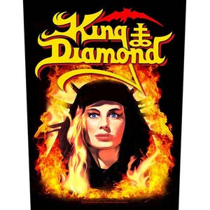 May include: A promotional image for King Diamond, featuring a woman with blue eyes and black hair, surrounded by flames. The band's name is in yellow and red stylized text at the top.