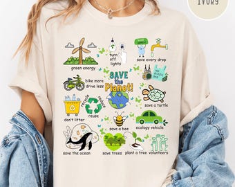May include: Ivory-colored t-shirt with a graphic promoting environmental conservation. The design includes illustrations of a wind turbine, bicycle, recycling symbol, and the text "SAVE the Planet!" Other phrases include "save every drop" and "save a turtle."