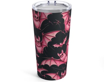 May include: A black and pink stainless steel tumbler with a repeating pattern of pink bats with black eyes and wings.