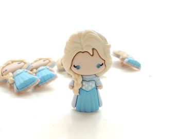 May include: A set of five blue and white plastic buttons featuring a cartoon character with blonde hair and a blue dress. The buttons are approximately 1 inch in diameter.