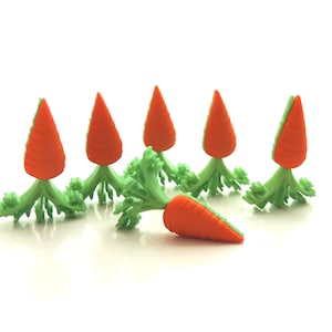 May include: A row of six orange and green carrot shaped erasers, with one carrot eraser lying on its side in front of the row.