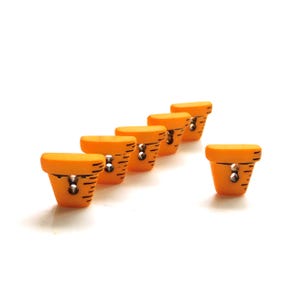 May include: Six orange, flower pot-shaped buttons with black markings and a silver-colored metal accent. The buttons are arranged in a diagonal line, with one button slightly offset from the others. The buttons are on a white background.